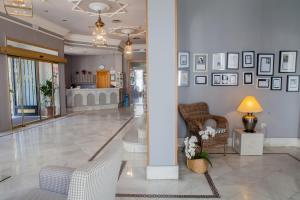 赫雷斯－德拉弗龍特拉的住宿－多尼亞布蘭卡酒店，大堂设有椅子和墙上的照片