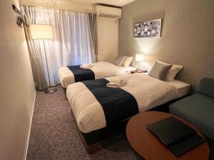 Postel nebo postele na pokoji v ubytování &haku Kyoto Marutamachi