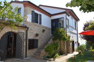 a house with a gate and a brick building at Antico Casale Fossacieca in Civitanova Marche