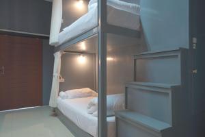 a bedroom with a bunk bed and a ladder to a bunk bed at Mee Hug Guesthouse in Phayao +23 photos