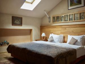 a bedroom with a large bed and a large window at Vinotel Boutique Hotel in Tbilisi City