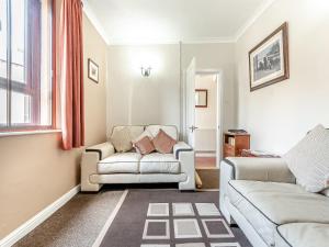 a living room with two chairs and a couch at River Cottage in Two Dales