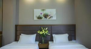 Ένα ή περισσότερα κρεβάτια σε δωμάτιο στο GreenTree Inn Taizhou Gaogang District Business Hotel