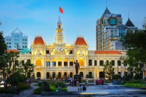 a building with a flag on top of it at Golden Lunar Hotel - Moonlight Stay in Bui Vien Walking Street in Ho Chi Minh City