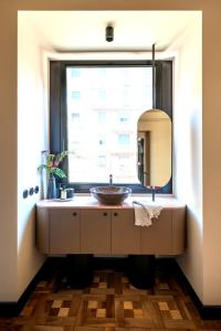 a bathroom with a sink and a window at HOMY Repubblica - A Luxury Collection in Milan