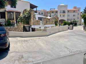 a car parked in a parking lot next to a building at Seagarden Hideaway - 1bed apt in Paphos