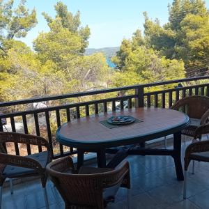 a table and chairs on a balcony with a view at Blue and Green in Neos Marmaras