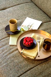a table with a plate with a dessert and a cup of coffee at HOMY Repubblica - A Luxury Collection in Milan +34 photos