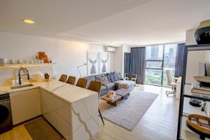 a kitchen and a living room with a couch at Premier Suites- Panoramic View in Cebu City