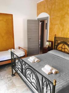 a bedroom with a bed with two towels on it at Bed & Breakfast Casa Galeano in Pizzo