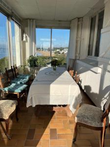 a room with a bed and two chairs and a window at Maison face mer ! in Pornichet