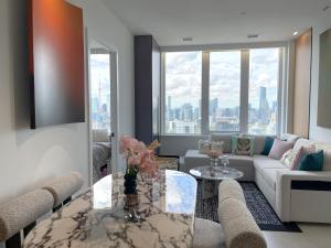 a living room with a couch and a table at Panoramic Skyline 2bedrooms Penthouse Suites CN Tower Toronto INFIVILLA in Toronto