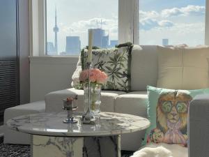 a living room with a couch and a table at Panoramic Skyline 2bedrooms Penthouse Suites CN Tower Toronto INFIVILLA in Toronto
