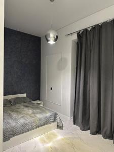 a bedroom with a bed and a gray curtain at Villa Merraki  +28 photos