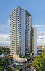 a large tall building in a city at Casa Paradise at 31 Sudirman Suites in Makassar