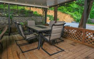 a patio table and chairs on a deck at Whiskey Ridge in Sevierville
