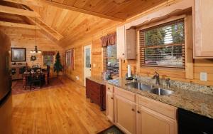 una cucina con lavandino e una sala da pranzo di Bear Tracks a Gatlinburg Altre 47 foto