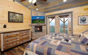 a bedroom with a bed with a fireplace and a tv at Bigger Bear Views Lodge in Gatlinburg +45 photos