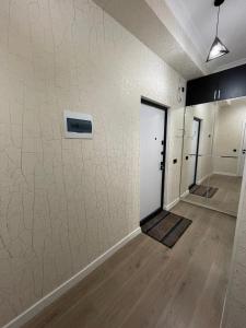 a room with white walls and a hallway with doors at ЖК Prime park in Shymkent