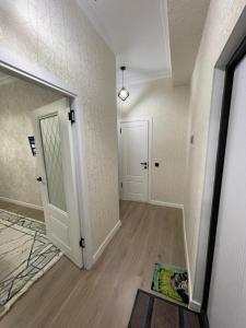 an empty room with a door and a hallway at ЖК Prime park in Shymkent