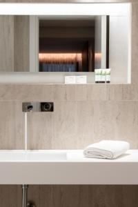 a bathroom with a white sink and a mirror at Sealuxe Living in Iraklitsa +64 photos