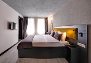 a bedroom with a large bed with a yellow headboard at Taksim Seya Suites Hotel in Istanbul