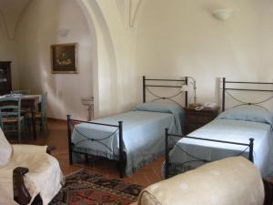 Postel nebo postele na pokoji v ubytování Relais Villa Sensano