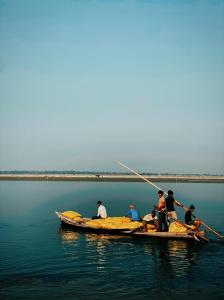 a group of people on a boat in the water at Rajiv Homestay in Kālīnagar +6 photos
