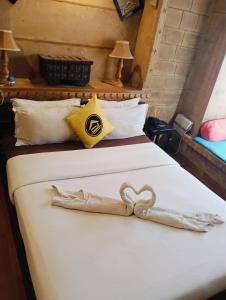a hotel room with two beds with a heart decoration on them at Hotel Tharventure in Jaisalmer +2 photos