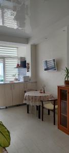 a kitchen with a table and a kitchen with a counter at уют in Dobrovelychkivka
