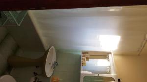 a small bathroom with a toilet and a sink at Apartments Vidakovic in Ugljan