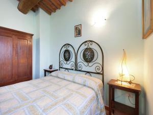 a bedroom with a bed and a wooden cabinet at Farmhouse in Apecchio with Swimming Pool, Terrace, Garden in Apecchio +125 photos