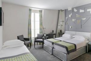 Ένα ή περισσότερα κρεβάτια σε δωμάτιο στο Hôtel A La Villa des Artistes