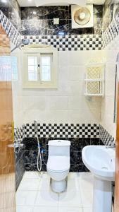 a bathroom with a toilet and a sink at شاليهات ووحدات فندقية وشقق مفروشة بالباحة - العقيق in Al ‘Aqīq +22 photos