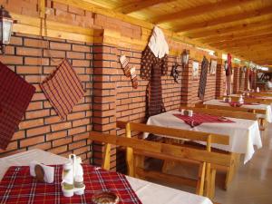 a dining room with two tables and chairs in a cabin at Complex Laguna-Kantardzhiev in Primorsko