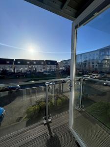 a balcony with a view of a parking lot at Cosy & Homely Stay in Maidenhead in Maidenhead +12 photos
