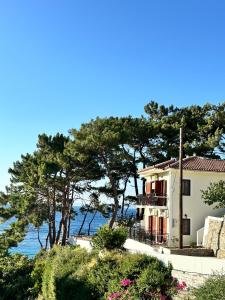 a house with a view of the water at Rooms Lemonakia Beach in Kokkari