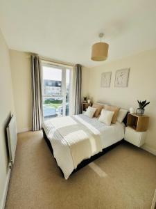 a bedroom with a bed and a large window at Cosy & Homely Stay in Maidenhead in Maidenhead