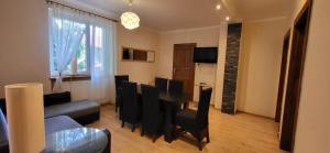 a living room with a table and black chairs at 300 mil in Szklarska Poręba