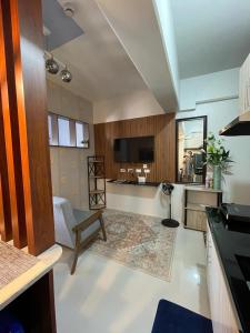 a large living room with a table and a chair at Coastal Stay at Oceancrest in Cebu City