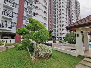 a tree in the courtyard of a building at Coastal Stay at Oceancrest in Cebu City