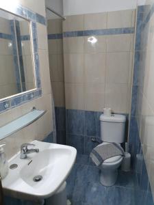 a bathroom with a sink and a toilet at Villa Anastasia Olympic Beach in Olympiaki Akti