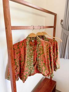 a group of shirts hanging on a rack at Relax in Nature Villa Namu no2 in Kuta Lombok