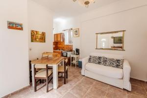 a living room with a couch and a table at Villa-Toula in Roda