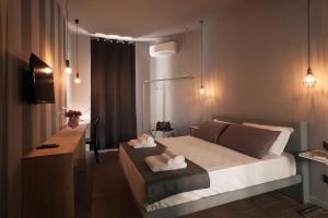 a bedroom with a bed and a desk in it at Dimora Villareale in Palermo