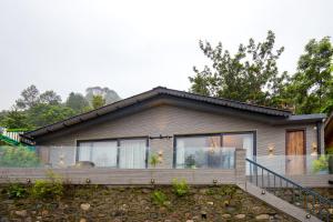 a small house with a balcony in front of it at SaffronStays Miorah in Bhowāli
