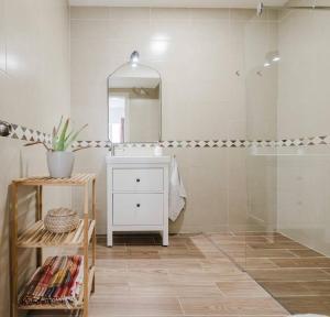 a bathroom with a white sink and a mirror at Solea Apartment In Mellieha By Homely! in Mellieħa +45 photos