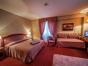 Postel nebo postele na pokoji v ubytování Hotel Valdarno