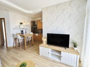 洛斯克里斯蒂亚诺斯Apartamentos Ohana - Edificio Tonillo的客厅里有一台平板电视和娱乐中心