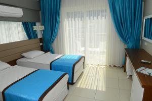 Postel nebo postele na pokoji v ubytování Marcan Resort Hotel